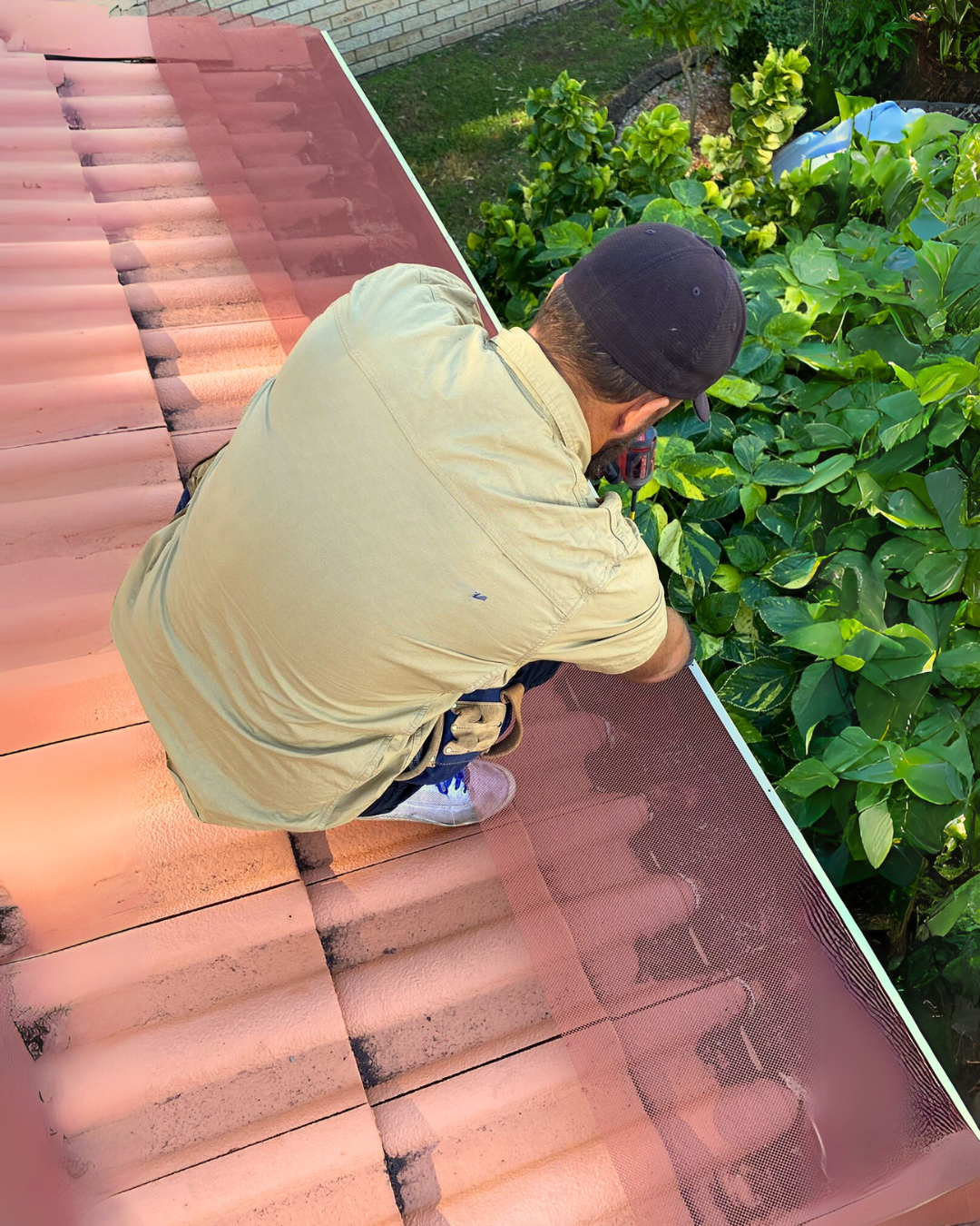 Gutter guard being secured over roof edge near