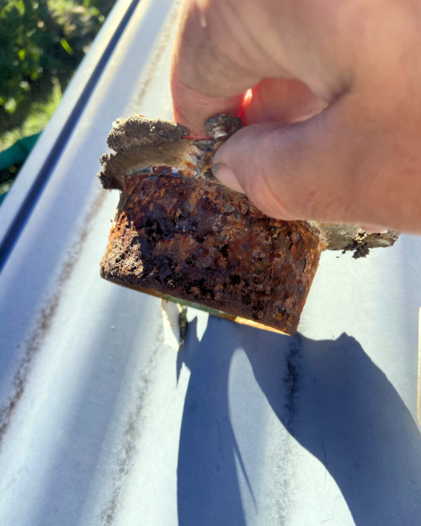 Severely rusted metal part of downpipe
