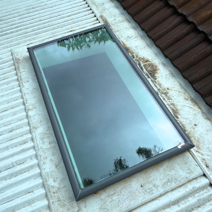 Cleaned skylight glass reflecting sky after full skylight cleaning.